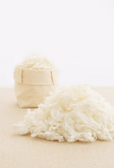 A bag of wool and a pile of wool